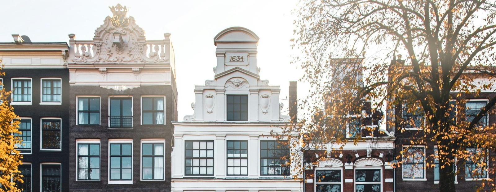 Canal houses along an Amsterdam canal in autumn light