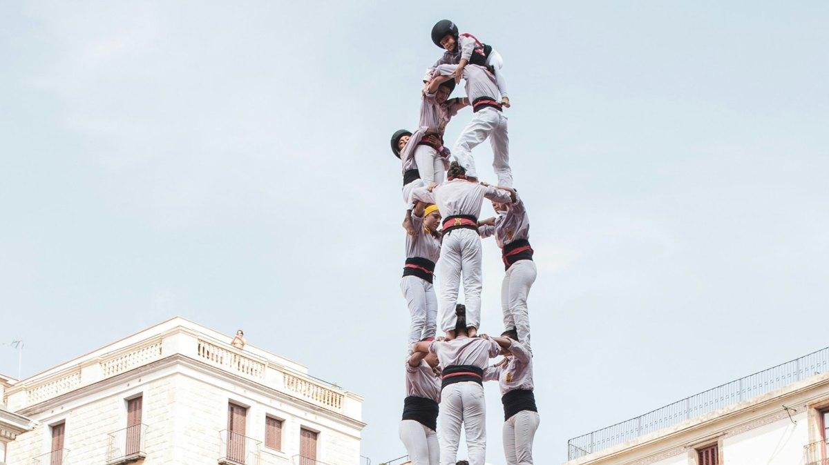 A human tower: a team climbing higher by holding each other up